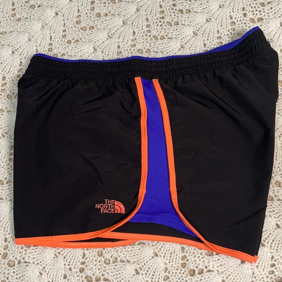 Black North Face running shorts with orange and blue accents - Picture 2 of 4